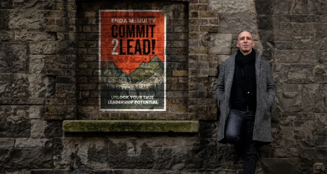 Professional by 'Commit 2 Lead' poster, symbolising McNulty's team performance coaching.