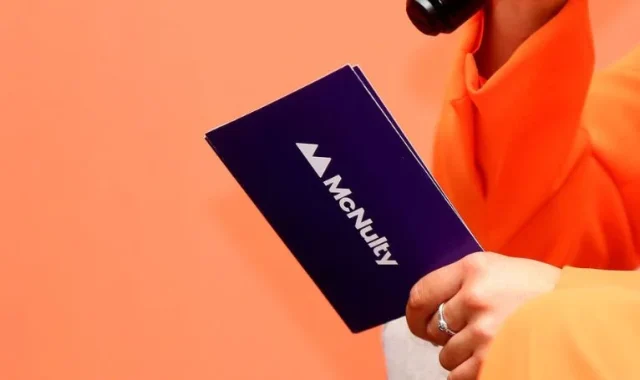 A person holding a McNulty branded notebook, symbolising bespoke transformational learning.