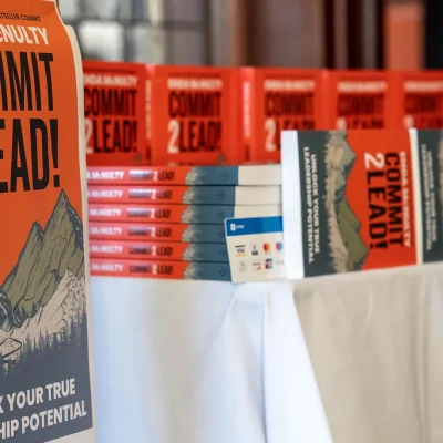 Display of Commit 2 Lead books on a table, featuring motivational covers.