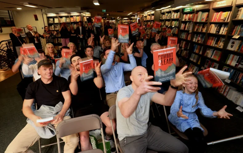 Audience celebrating at Hodges Figgis book signing event for 'Commit 2 Lead'.