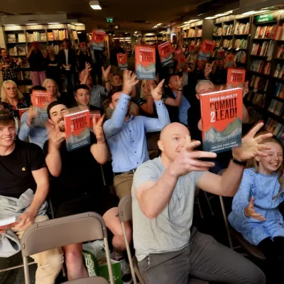 Audience celebrating at Hodges Figgis book signing event for 'Commit 2 Lead'.