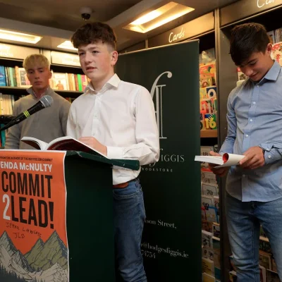 Group of young speakers discussing 'Commit 2 Lead' at Hodges Figgis bookstore.