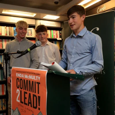 Young speakers presenting at Hodges Figgis during a 'Commit 2 Lead' event.