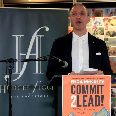 Author presenting at Hodges Figgis bookstore with 'Commit 2 Lead' book on display.