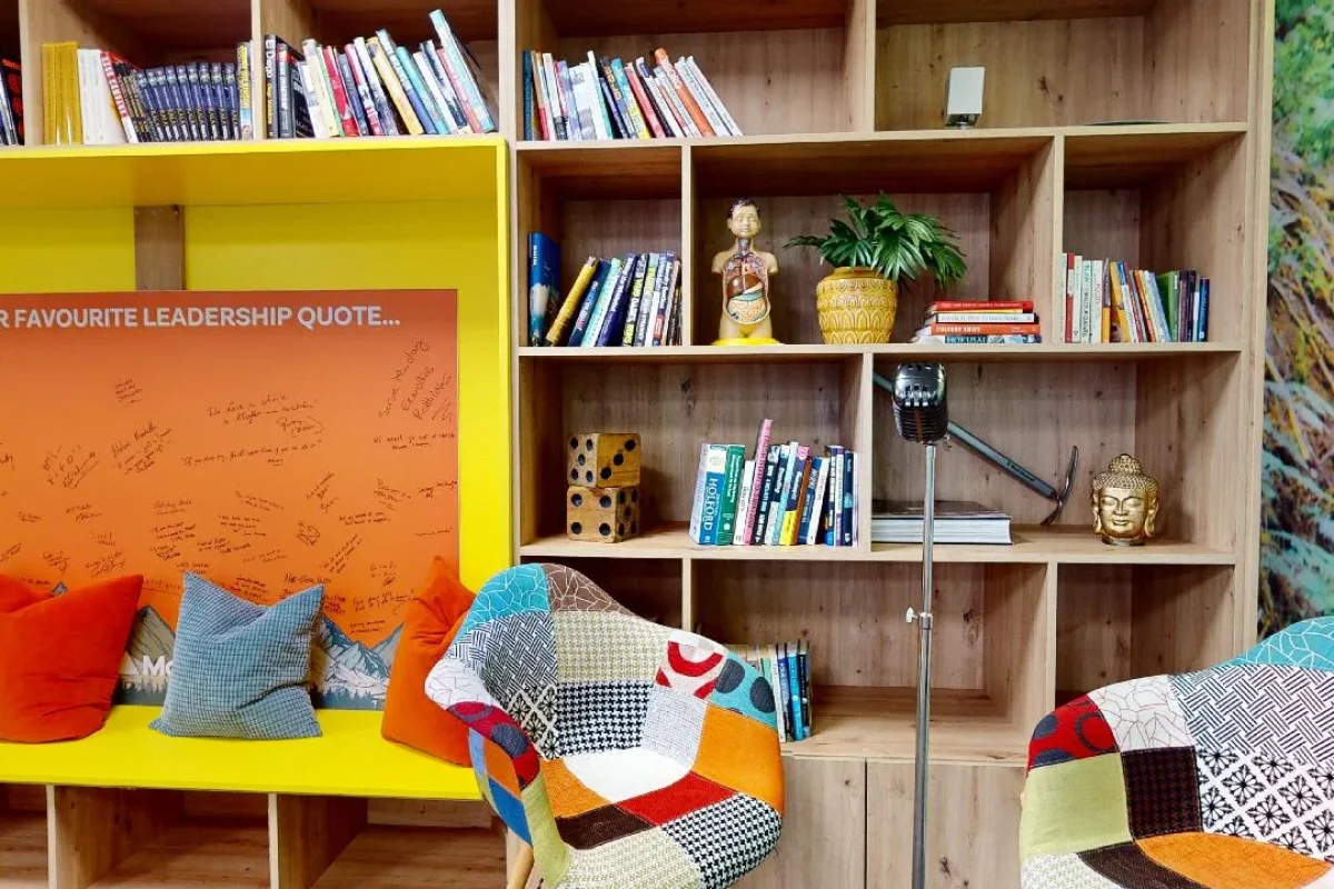 A creatively decorated bookshelf and wall at McNulty HQ that reflects the company's innovative culture.